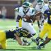 Michigan junior safety Jordan Kovacs reaches after Eastern Michigan Blake Poole as Michigan junior cornerback J.T. Floyd looks on during the fourth quarter at Michigan Stadium on Saturday. Melanie Maxwell I AnnArbor.com
